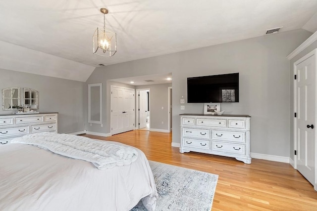 bedroom featuring an inviting chandelier, baseboards, lofted ceiling, light wood-type flooring, and visible vents