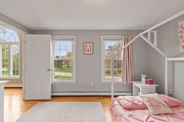 bedroom featuring a baseboard radiator and light wood-type flooring
