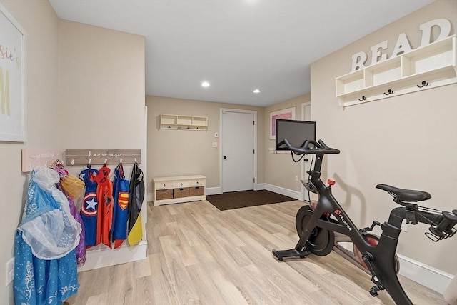 workout room with baseboards, recessed lighting, and wood finished floors