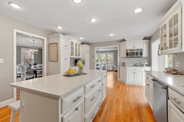 kitchen featuring light countertops, white cabinets, and stainless steel appliances