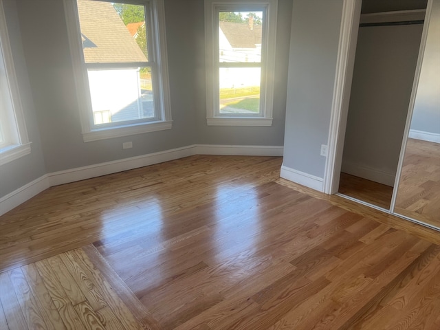 unfurnished bedroom with light hardwood / wood-style floors and a closet