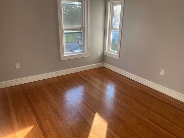 empty room with hardwood / wood-style flooring