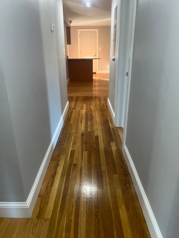 hallway with dark wood-type flooring