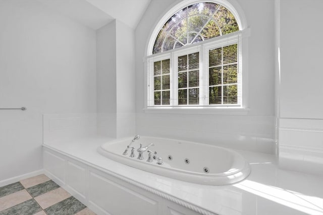 20 Ericka Cir, East Longmeadow, MA 01028 - bathroom with a tub with jets, vaulted ceiling, and baseboards