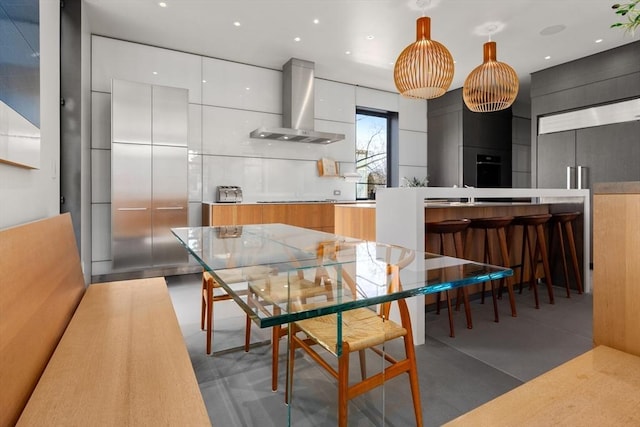 55 Fayerweather St, Cambridge, MA 02138 - kitchen featuring cooktop, wall chimney exhaust hood, modern cabinets, and white cabinetry