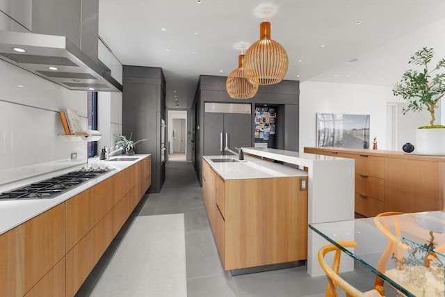 55 Fayerweather St, Cambridge, MA 02138 - kitchen with wall chimney exhaust hood, modern cabinets, a kitchen island with sink, paneled built in refrigerator, and stainless steel gas cooktop