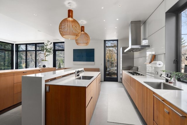 55 Fayerweather St, Cambridge, MA 02138 - kitchen featuring an island with sink, wall chimney exhaust hood, modern cabinets, and a sink