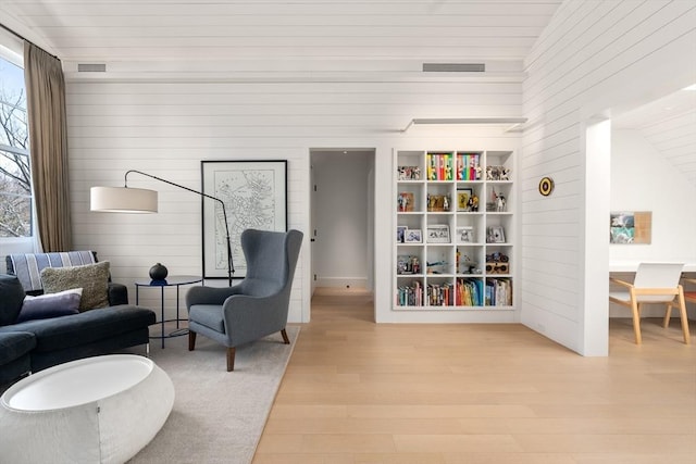 55 Fayerweather St, Cambridge, MA 02138 - living area featuring wood finished floors, wooden walls, and visible vents