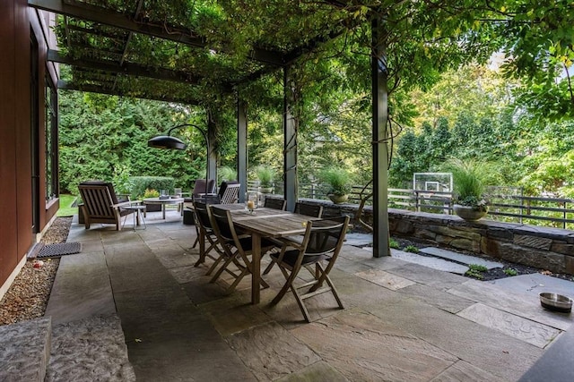 55 Fayerweather St, Cambridge, MA 02138 - view of patio featuring outdoor dining area, fence, and a fire pit