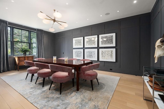 55 Fayerweather St, Cambridge, MA 02138 - dining room with an accent wall, a notable chandelier, a decorative wall, light wood-type flooring, and recessed lighting