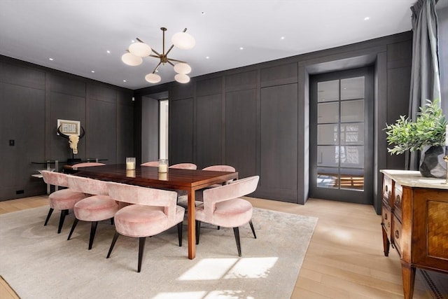 55 Fayerweather St, Cambridge, MA 02138 - dining area with a decorative wall, light wood finished floors, and a chandelier