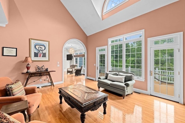 15 Henrys Ln, Norwell, MA 02061 - living area with high vaulted ceiling, light wood-type flooring, and baseboards