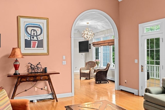 15 Henrys Ln, Norwell, MA 02061 - entryway with a baseboard radiator, light wood finished floors, baseboards, and arched walkways