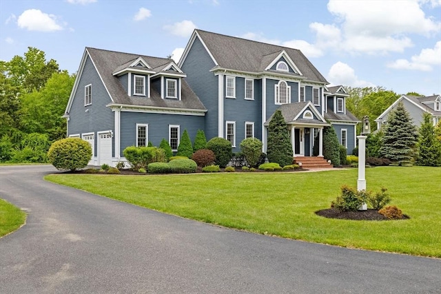 15 Henrys Ln, Norwell, MA 02061 - view of front of house featuring an attached garage, a front lawn, and asphalt driveway
