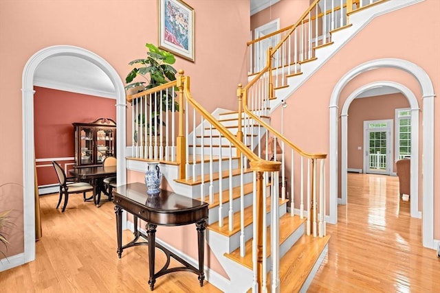 15 Henrys Ln, Norwell, MA 02061 - stairway with arched walkways, wood finished floors, crown molding, a towering ceiling, and baseboards