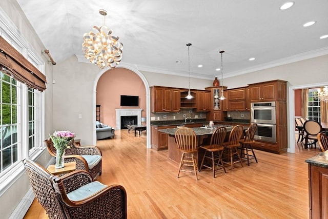 15 Henrys Ln, Norwell, MA 02061 - kitchen with stainless steel double oven, a sink, a chandelier, a kitchen breakfast bar, and a center island