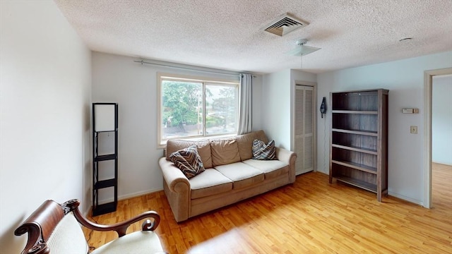 35 Prospect St Unit 309, Woburn, MA 01801 - living room featuring wood finished floors and a textured ceiling