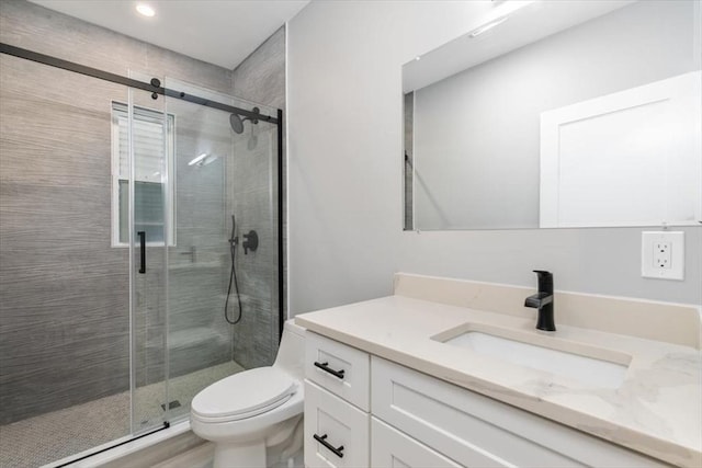 full bath featuring a shower stall, vanity, toilet, and recessed lighting