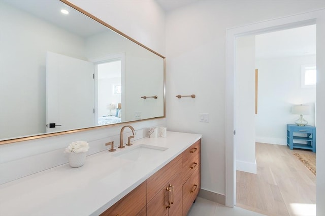 25 W Ave, Marion, MA 02738 - ensuite bathroom with connected bathroom, vanity, recessed lighting, baseboards, and wood finished floors