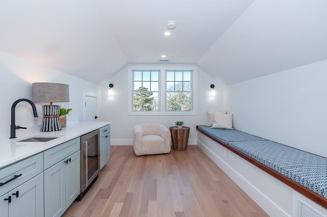 25 W Ave, Marion, MA 02738 - bedroom with a sink, beverage cooler, light wood-style flooring, baseboards, and vaulted ceiling