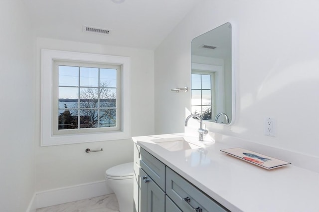 25 W Ave, Marion, MA 02738 - half bathroom featuring visible vents, marble finish floor, baseboards, and toilet
