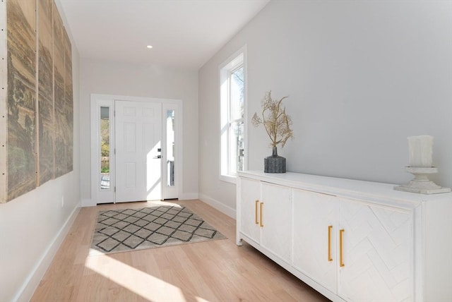 entrance foyer with light wood-style floors and baseboards