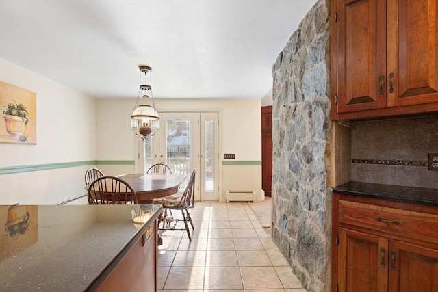 dining space featuring light tile patterned floors and baseboard heating