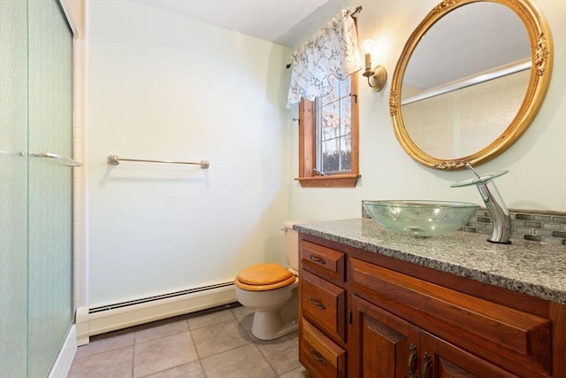 bathroom with vanity, a baseboard radiator, tile patterned floors, and toilet