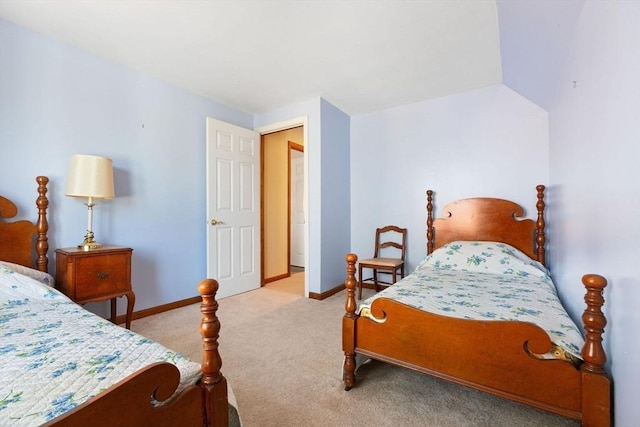 bedroom with lofted ceiling and light carpet