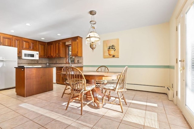 dining room featuring a chandelier, light tile patterned floors, and baseboard heating