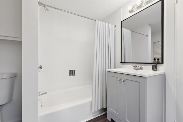 full bathroom with vanity, hardwood / wood-style flooring, shower / tub combo with curtain, and toilet