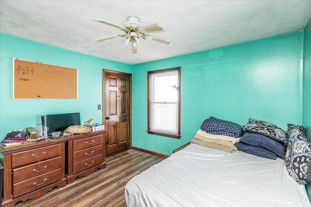 bedroom featuring dark hardwood / wood-style floors and ceiling fan