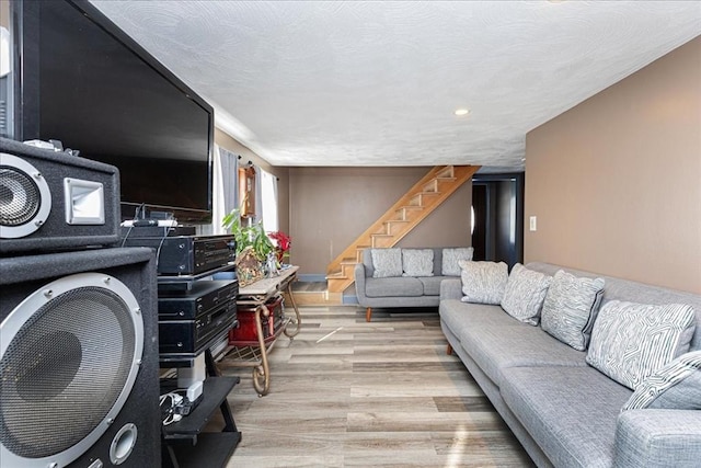 living room featuring light hardwood / wood-style floors and a textured ceiling