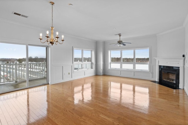 unfurnished living room featuring crown molding, a high end fireplace, and light wood-type flooring