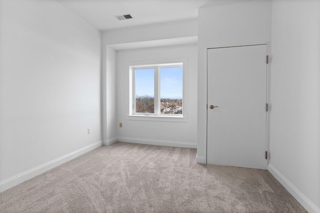 empty room featuring light colored carpet