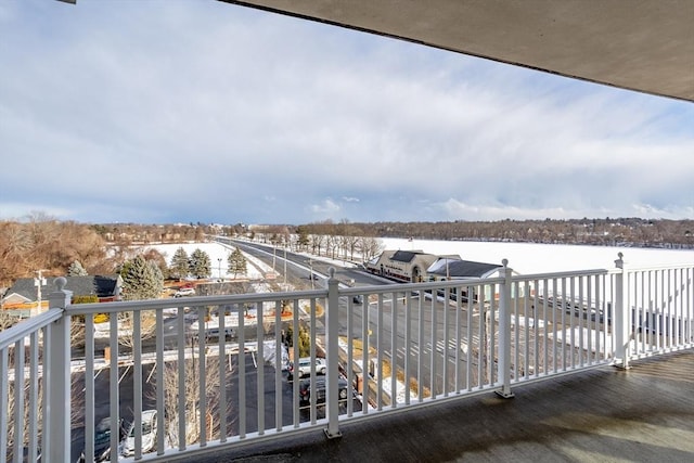 view of snow covered back of property