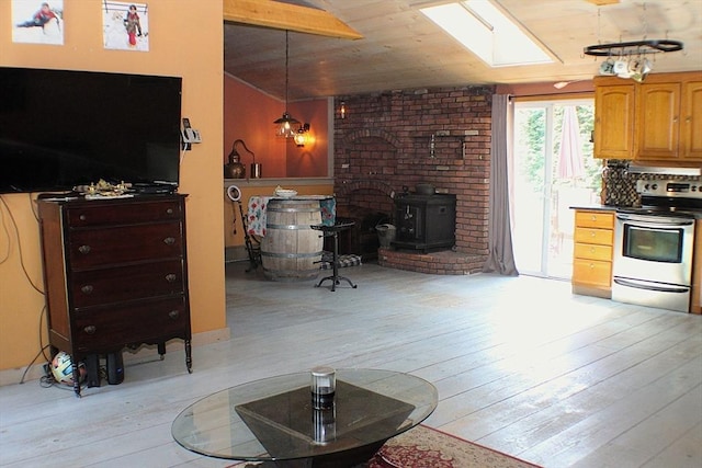 155 Old Palmer Rd, Brimfield, MA 01010 - kitchen featuring electric stove, a skylight, a wood stove, light wood finished floors, and lofted ceiling