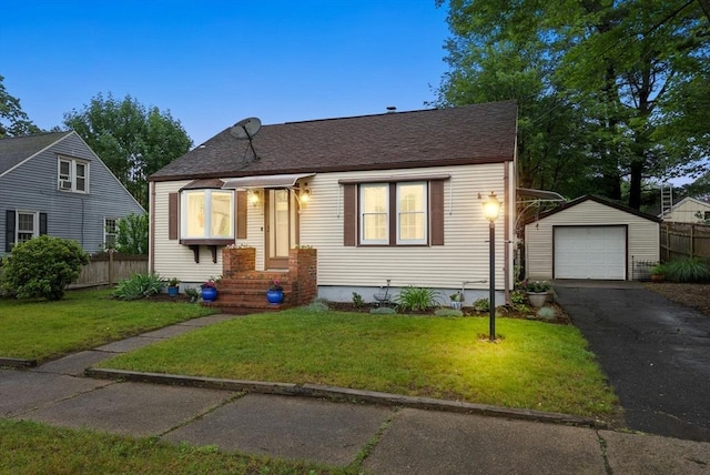 97 Connecticut Ave, Springfield, MA 01104 - bungalow featuring an outbuilding, asphalt driveway, a garage, and a shingled roof