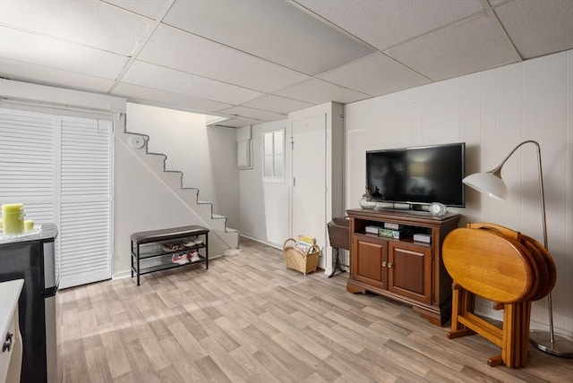 97 Connecticut Ave, Springfield, MA 01104 - living room featuring a paneled ceiling, light wood-style flooring, and stairs