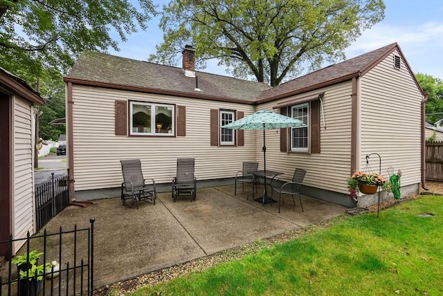 97 Connecticut Ave, Springfield, MA 01104 - back of property featuring a chimney and a patio area