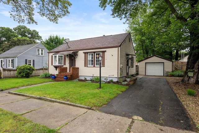 97 Connecticut Ave, Springfield, MA 01104 - view of front of property featuring an outbuilding, a detached garage, driveway, and a shingled roof
