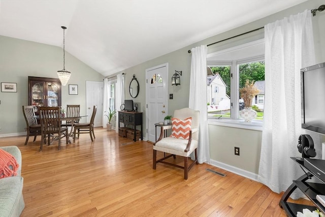 97 Connecticut Ave, Springfield, MA 01104 - living room with light wood finished floors, vaulted ceiling, and a chandelier