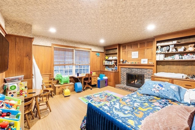 285 Still River Rd, Bolton, MA 01740 - bedroom with wood walls, wood finished floors, and a fireplace