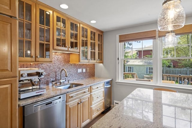 kitchen featuring glass insert cabinets, a sink, tasteful backsplash, dishwasher, and light stone counters