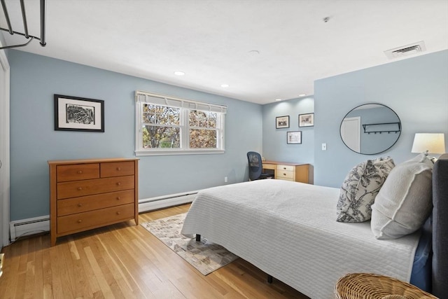 bedroom featuring a baseboard heating unit, recessed lighting, light wood-style flooring, and visible vents