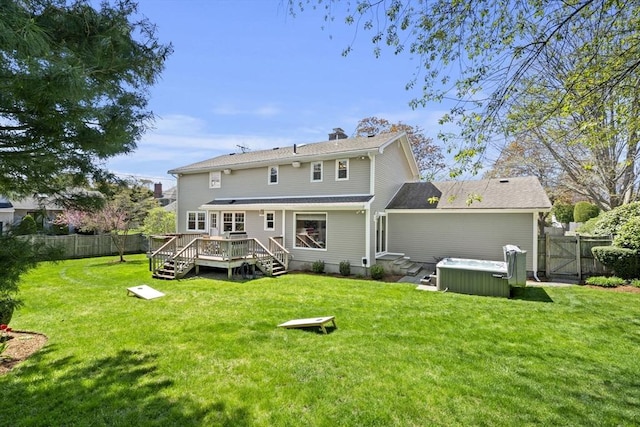 back of property featuring a fenced backyard, a wooden deck, and a yard