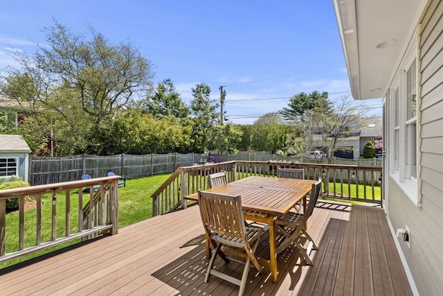 deck with a yard, a fenced backyard, and outdoor dining area