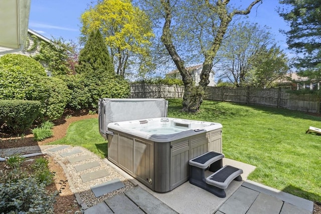 view of yard featuring a hot tub and a fenced backyard
