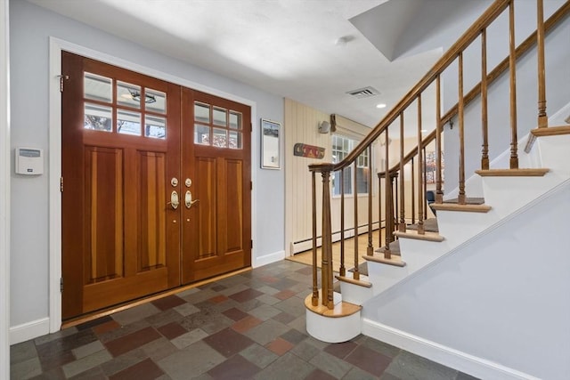 entryway featuring baseboards, a baseboard radiator, visible vents, and stairway