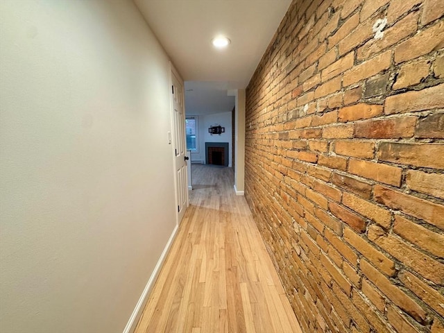 191 W Canton Unit 1, Boston, MA 02116 - hallway with brick wall, light wood-style floors, baseboards, and an accent wall